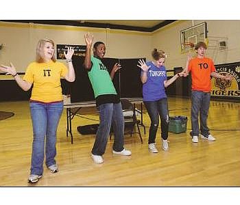 Emily Myers, Darius Carter, Ashley Sweeney and Austin Perkins, high school actors from the Second Chance Foundation, perform skits for older students at St. Francis Xavier Elementary School. 