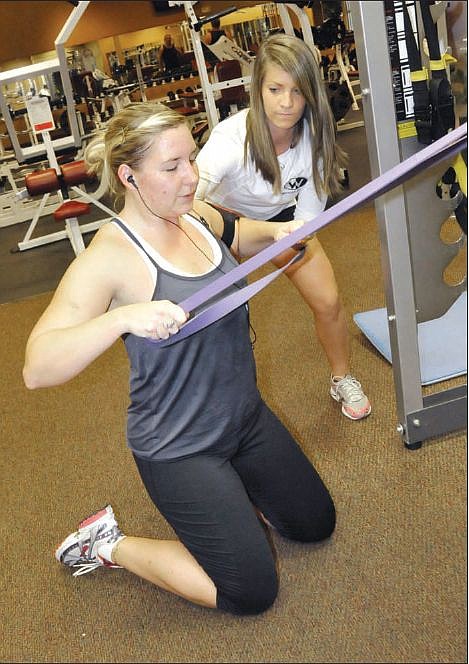 Personal trainer Jennifer Brown assists Rachelle Zbinden during her workout Thursday, Oct. 7, 2010 at Wilson's Fitness. Wilson's was named the Jefferson City Area Chamber of Commerce 2010 Small Business of the Year. 