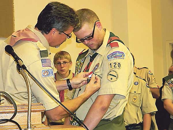 Troop 368 Scoutmaster Rob Lorey pins the Eagle Scout Pin on James Stewart (Jimtu) Hogue during his Eagle Scout Award Ceremony held Sunday, Oct. 24 at the United Church of Christ, California.