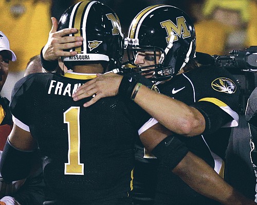 Missouri quarterback Blaine Gabbert congratulates teammate James Franklin after Franklin's 3-yard touchdown run during the fourth quarter of Saturday night's game against Oklahoma at Faurot Field. 