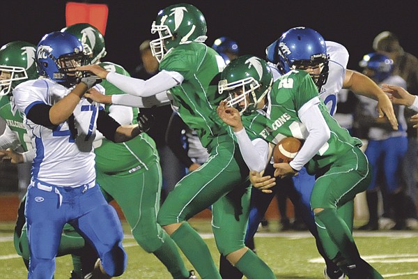 Blair Oaks running back Jacob Graessle follows the block of J.J. Kresl during the fourth quarter of Thursday night's game with the Mongomery County Wildcats at the Falcon Athletic Complex. To view this and other photographs, please visit www.newstribune. com/photos.