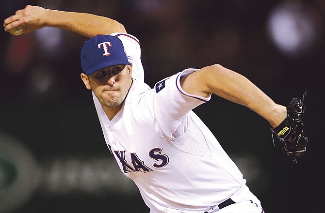 Texas Rangers' Darren O'Day throws during the eighth inning of Game 3 of baseball's World Series against the San Francisco Giants Saturday, Oct. 30, 2010, in Arlington, Texas.