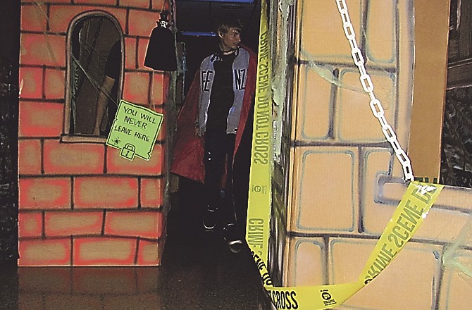 In this Oct. 31, 2010 photo, Tyler Wakeland, 17, Jefferson City, wears a vampire cape as he strolls through the Haunted Precinct at the Jefferson City Police Department.