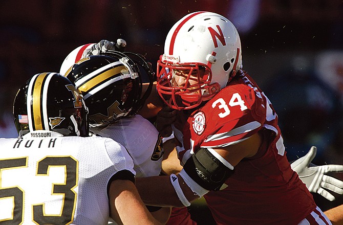 Missouri quarterback Blaine Gabbert (center) is tackled by Nebraska defensive end Cameron Meredith in the first half of Saturday's game in Lincoln, Neb. Meanwhile, MU Coach Gary Pinkel is asking the Big 12 to look at videotape of Cornhusker Courtney Osborne's hit on the Tigers' quarterback in the fourth quarter.