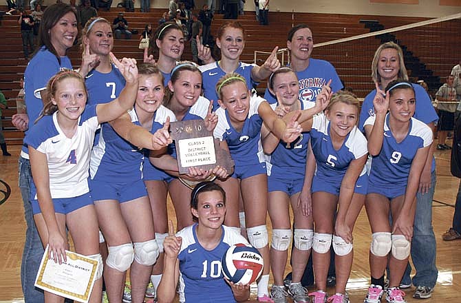 The California High School varsity volleyball team defeated Cole Camp and Stover at the Class 2 District 13 Volleyball Tournament at Versailles Tuesday, Oct. 26, to capture the district title. Celebrating the victory, seated, is Sydney Deeken; front row, from left, are Kaitlyn Allison, Erin Cary, Kelci Dampf, Lesa Langlotz, Audrey Imhoff, Stephanie Pugh and Abby Lueckenotte; back row, Coach Tammy Reynolds, Holly Wolfrum, Karin Bolinger, Beth Crow, Coach Ashley Atteberry and Coach Heather Henley. 