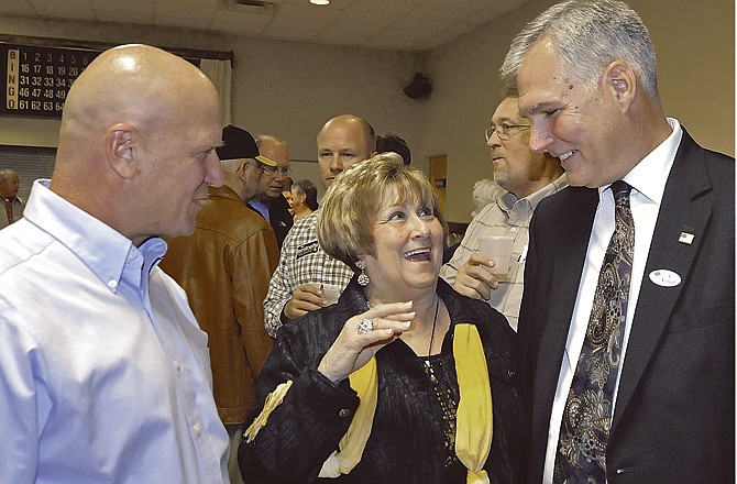 Candidates Mike Bernskoetter and Mark Richardson talk with Patty Howell on Tuesday night at the Republican watch party at the American Legion banquet room. 