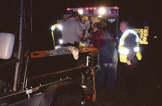 Rescue workers tend to a man who was lost and injured in woods near Highway 179 in southern Jefferson City on Wednesday.