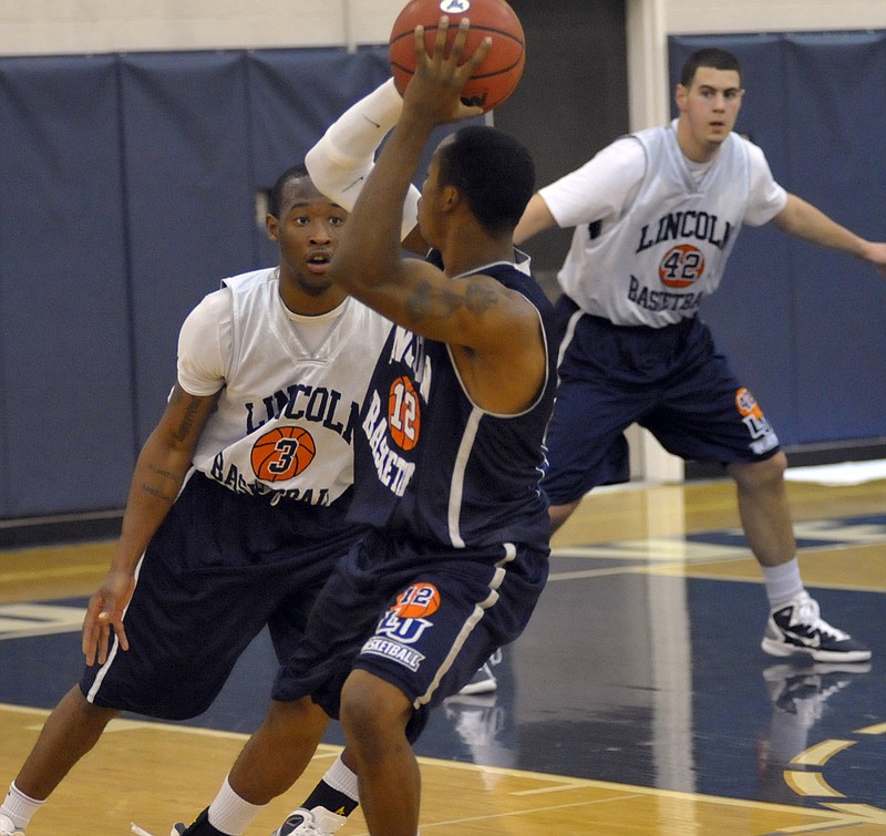 Lincoln's Marquez Davis (3) guards teammate Cedric Ridle Jr. during a recent practice at Jason Gym. Looking on for the Blue Tigers is Tim Carter. 