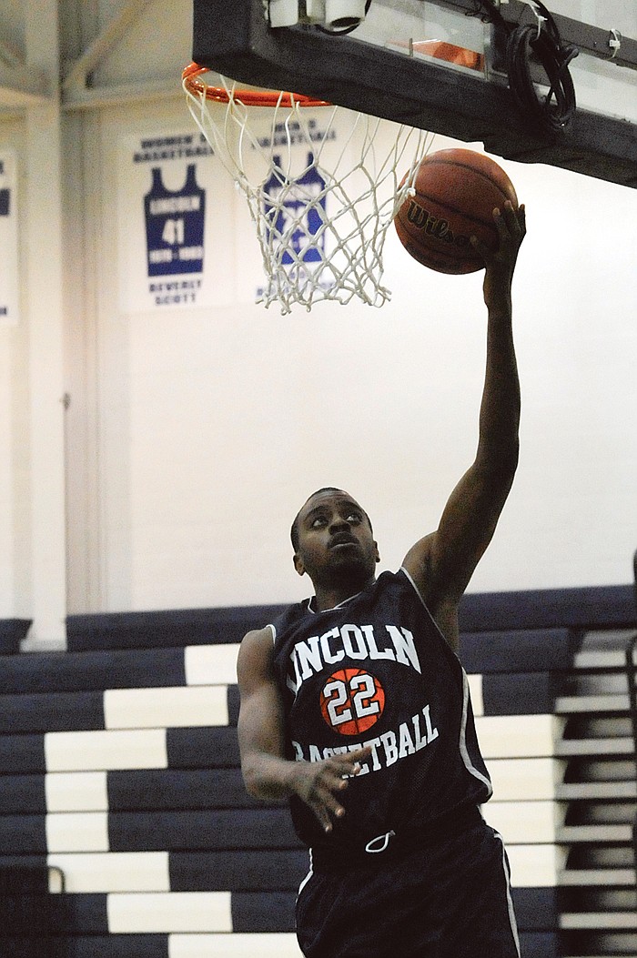 Lincoln's Matt Morris glides in for a layup during practice this week at Jason Gym. 