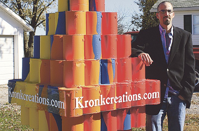 Scott Kronk stands beside a sculpture he made, which is on display in his yard. "This is what I want to do for a living," he said. His art can be viewed online at www.kronkcreations.com. 