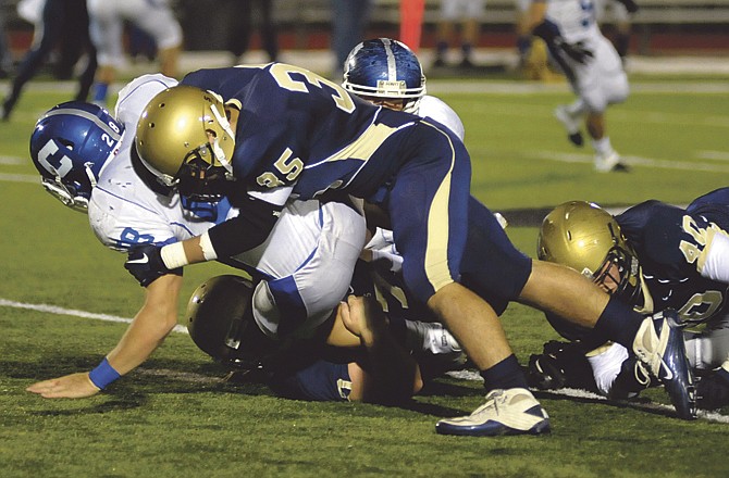 Helias' Justus Schulte brings down Carthage's Brian Poston during the Crusaders' regional win Wednesday at Adkins Stadium. The victory earned Helias a sectional game today with Webb City. 