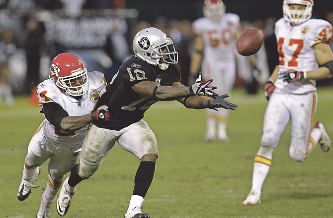 Raiders wide receiver Jacoby Ford catches a 47-yard pass despite the defense of the Chiefs' Brandon Flowers to set up the game-winning field goal Sunday in Oakland, Calif. 