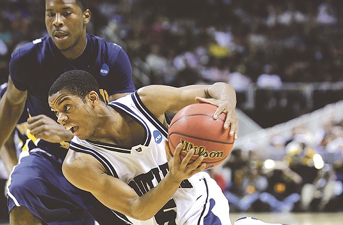 In this March 20, 2010, photo, Butler guard Ronald Nored, right, drives to the basket past Murray State guard Isacc Miles, left, during the second half of an NCAA college basketball tournament game in San Jose, Calif. Nored, a junior, says he thinks the team is better now than at the same time last year. Butler came within inches of bringing home a national title last year.