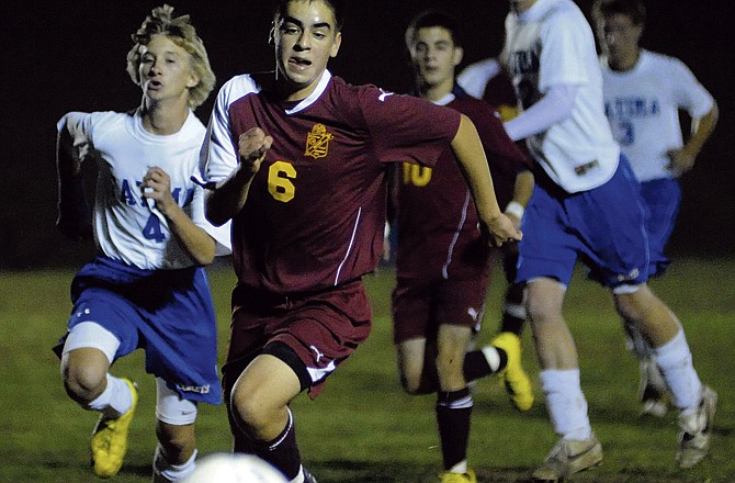 Fatima midfielder sophomore Zachary Pope (4) races midfielder Allan Gontes (6) of Missouri Military Academy for the ball during the first half of their Class 1 sectional match Tuesday evening in Westphalia.