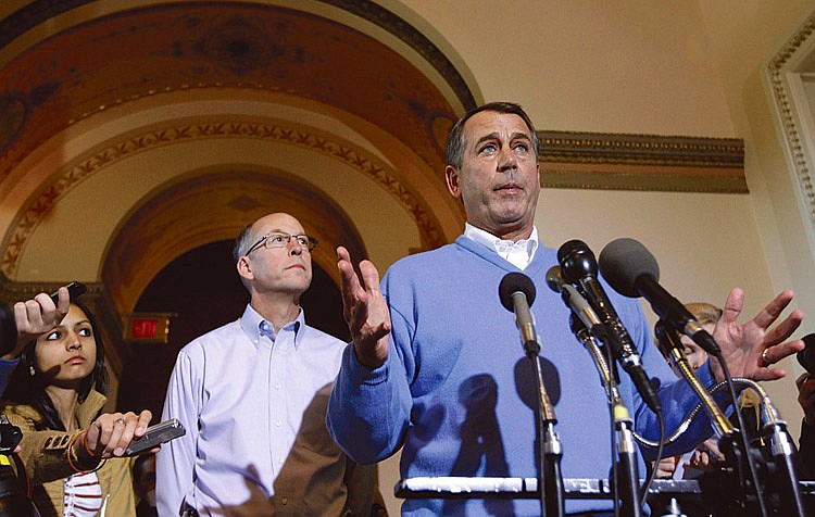 House Speaker-in-waiting John Boehner of Ohio, right, accompanied by Republican Majority Transition Chairman Rep. Greg Walden, ROre., speaks Wednesday during a news conference on Capitol Hill in Washington. 