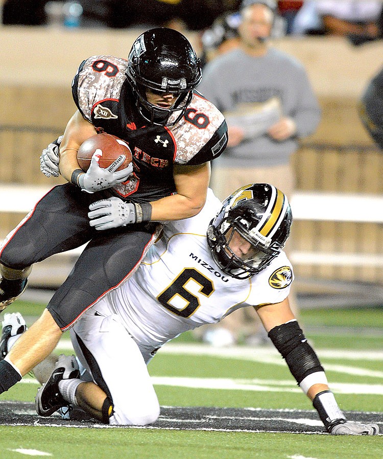 Misouri's Andrew Gachkar tackles Texas Tech's Austin Zouzalik during the second half of an NCAA college football game Saturday, Nov. 6, 2010, in Lubbock, Texas. Texas Tech beat Missouri 24-17.(AP Photo John A. Bowersmith)