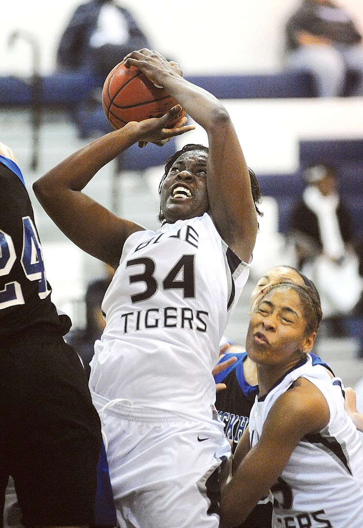 Junior forward Vivian Essuon, (34), fights for the ball against the Rockhurst Hawks Friday evening, Nov. 12, 2010, at Jason Gymnasium. The score was tied, 50-50, at the end of the second half.