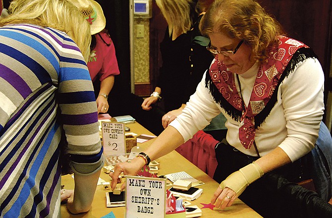 Women assemble custom greeting cards and sheriff's badges at Cowgirl Up, a fundraiser held Saturday. Proceeds from the cards go the group, which helps women find suitable clothing for job interviews. 