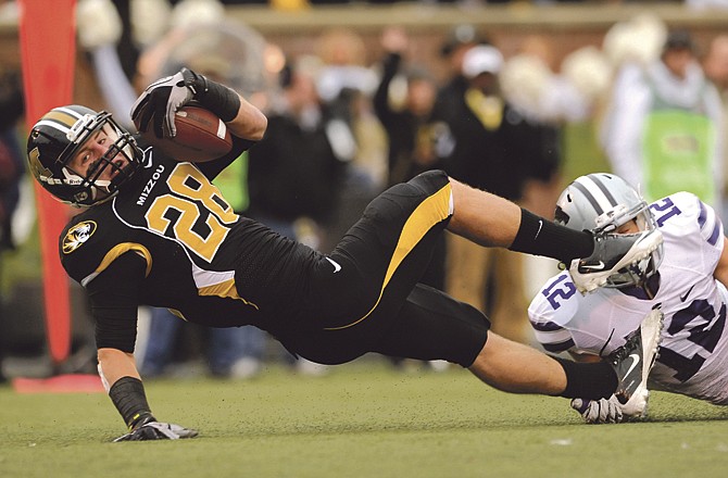 Missouri receiver T.J. Moe fights across the goal line for a touchdown as Ty Zimmerman of Kansas State tries to make a tackle during Saturday's game at Faurot Field. 