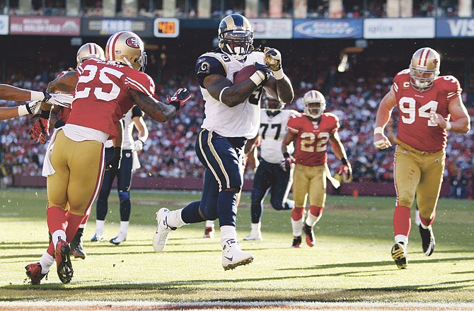 Rams running back Steven Jackson scores on a 13-yard run during Sunday's game against the 49ers in San Francisco. Among the 49er defenders is Justin Smith (94), a former Jefferson City Jay and Missouri Tiger. 