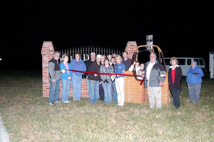 Ernie Timbrook Jr. cuts the ribbon at the California Area Chamber of Commerce event for the California Balloon Invitational, to be held July 16, 2011. The ribbon cutting was held at Windmill Ridge Thursday, Nov. 11, with many members of the Chamber present.