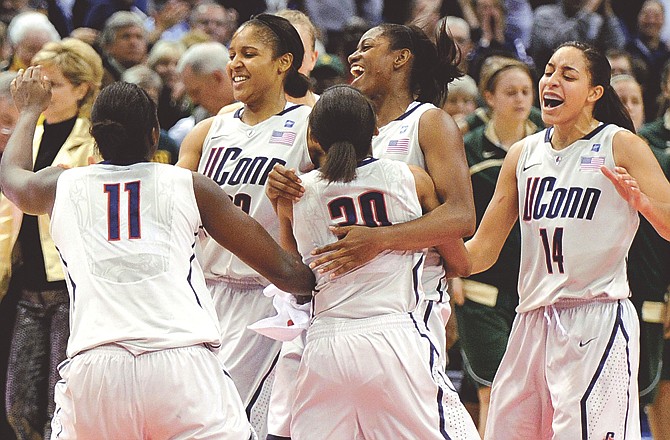 Connecticut players celebrate their 65-64 victory over Baylor on Tuesday night in Hartford, Conn.