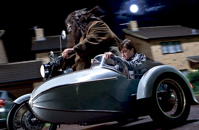 In this film publicity image released by Warner Bros. Pictures, Robbie Coltrane, left, and Daniel Radcliffe are shown in a scene from "Harry Potter and the Deathly Hallows: Part 1." 