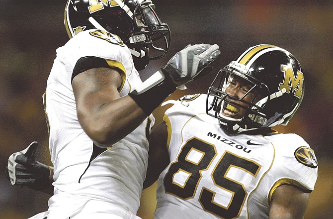 Missouri defensive lineman Jacquies Smith (left) congratulates teammate Aldon Smith after he sacked Illinois quarterback Juice Williams during the fourth quarter of last year's game in St. Louis. 