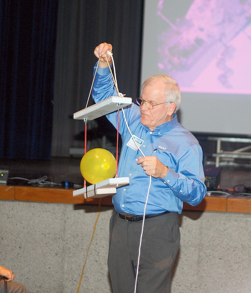 NASA Education Specialist Pat Daugherty does an experiment for students of South Callaway Middle School on Thursday. The experiment was meant to show the students what happens to gravity during a freefall to and from Earth.