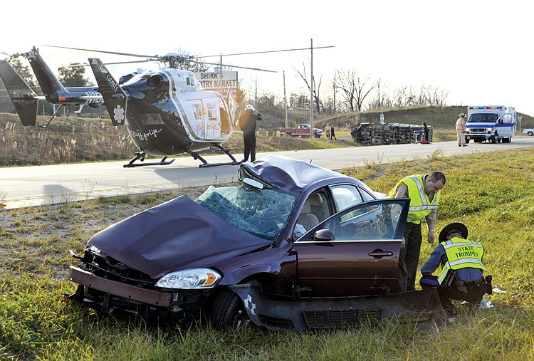 Stephen Brooks/News Tribune.A an accident between a Chevrolet Impala and a Kenworth dumptruck on US 50 and Route U Friday afternoon. The lifeflight helicopter stands by to take the truckdriver from the ambulance.