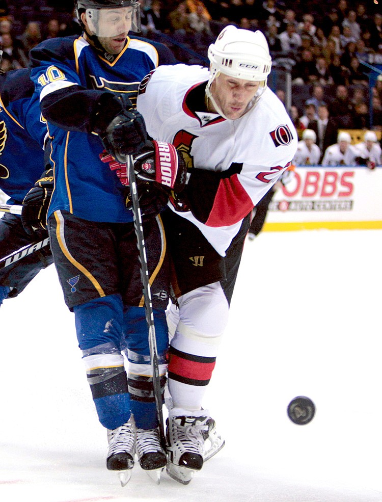 St. Louis Blues' Andy McDonald, left, and Ottawa Senators' Alexei Kovalev, of Russia, chase a loose puck during the first period of an NHL hockey game Friday, Nov. 19, 2010, in St. Louis. (AP Photo/Jeff Roberson)