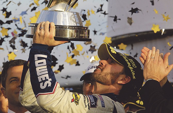 Jimmie Johnson hoists the trophy after winning his fifth consecutive NASCAR Sprint Cup championship Sunday in Homestead, Fla. 