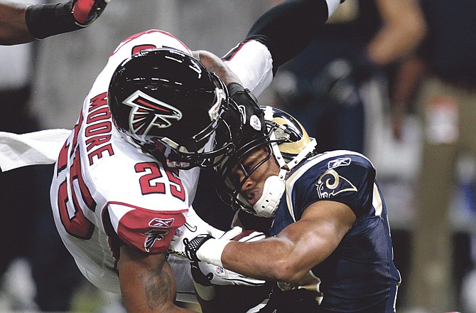 Falcons safety William Moore (25), a former Missouri Tiger, tackles Rams wide receiver Laurent Robinson during the first quarter of Sunday's game in St. Louis. 