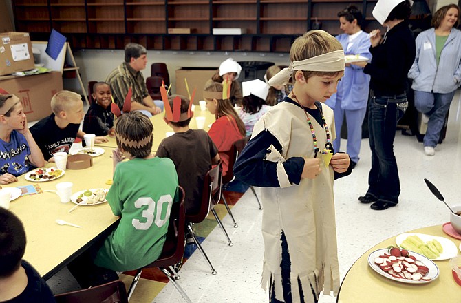 Fifth-grader Max Allen, right, looks over the buffet table after he and fellow members of Melissa Renfro's class sampled traditional foods such as venison, turkey, fish, cucumbers, radishes, salad, rolls and honey during a Thanksgiving feast Tuesday at Cedar Hill Elementary School. 