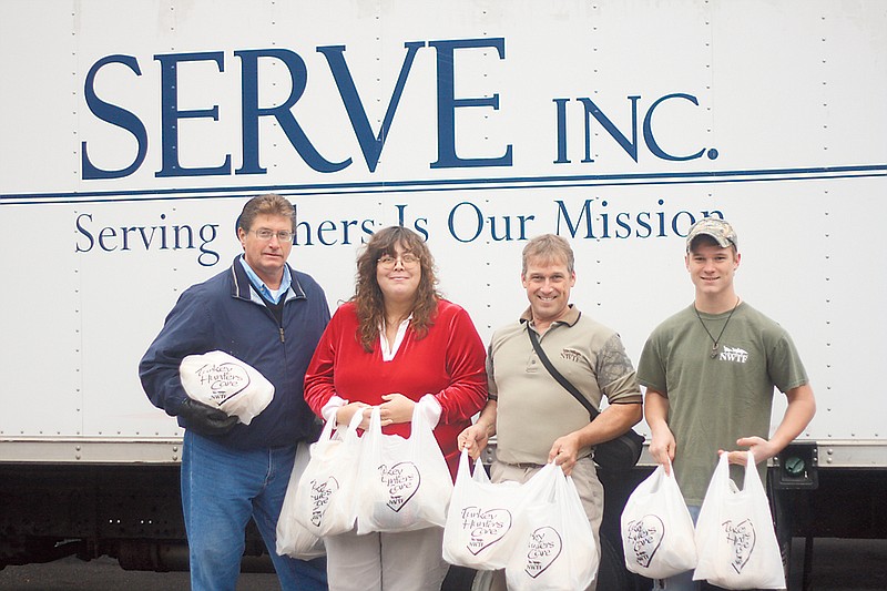 Stephanie Backus/FULTON SUN photo
Don Masek, Julie Roark, John Burk and Logan Burk hold turkeys donated to SERVE by the local chapter of the National Wild Turkey Federation. The organization donated a dozen turkeys to SERVE on Wednesday.