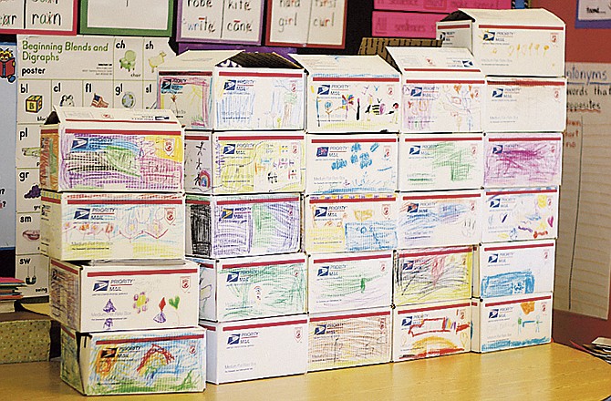 Kathleen Wilson's first grade class at Bartley Elementary in Fulton filled and decorated boxes for soldiers. The boxes are being mailed to reach the soldiers by Christmas. 