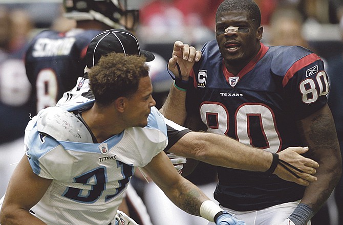 Houston Texans wide receiver Andre Johnson (80) and Tennessee Titans cornerback Cortland Finnegan (31) are separated following a fight in the fourth quarter Sunday in Houston. Both players were ejected from the game. The Texans beat the Titans 20-0. 