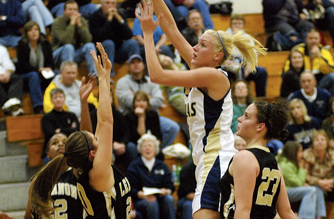 Krista Haslag, shown putting up a shot while surrounded by Lebanon defenders last year, will give Helias an inside force this season. 