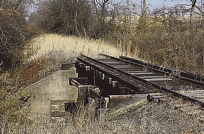 The Fulton railroad spur is overgrown with grass and weeds at a point just north of University Avenue in Fulton. 