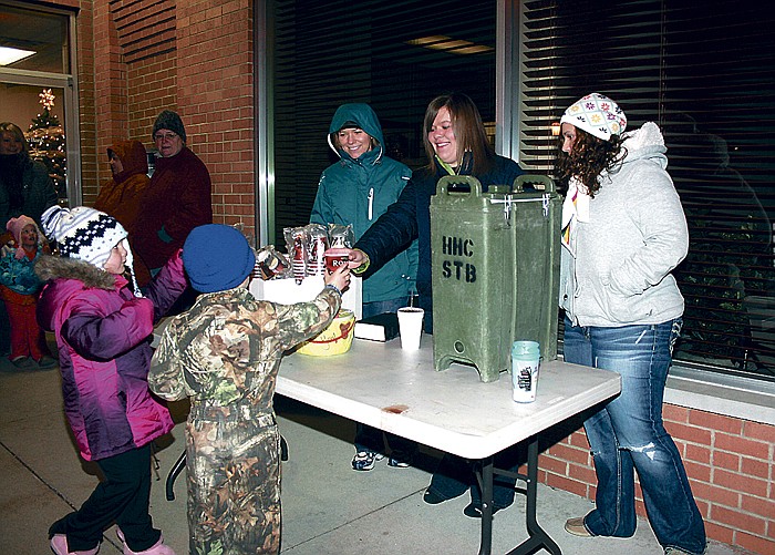 California Girl Scouts from Troop 231 sell hot cocoa in front of Commerce Bank Saturday after the California Christmas Parade.