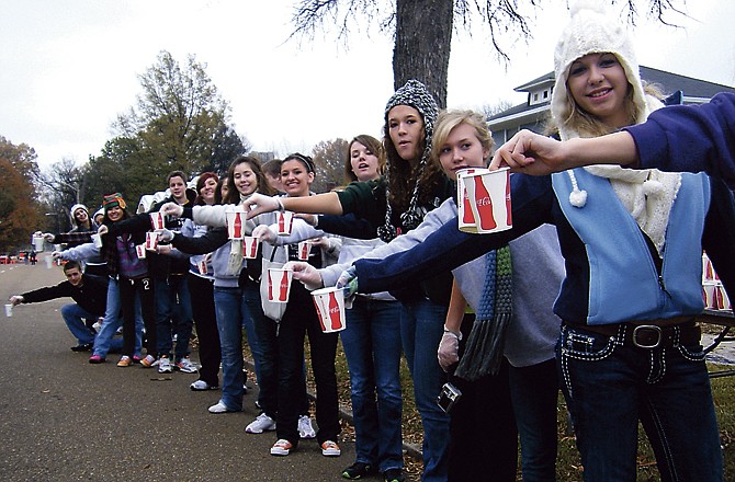 Helias students wait to pass out cups of water and Powerade at the 6-mile marker of the St. Jude marathon. 