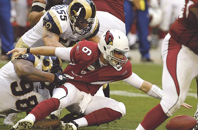 Cardinals quarterback Max Hall (6) fumbles the ball as he is hit by the Rams' James Laurinaitis (55) and Fred Robbins (98) during the fourth quarter of Sunday's game in Glendale, Ariz. Hall recovered the ball but was injured on the play and did not return as the Rams defeated the Cardinals 19-6. 