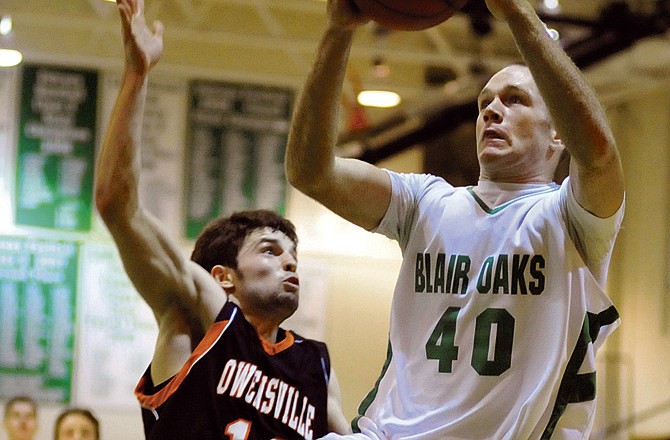 Blair Oaks' Lucas Doerhoff drives to the hoop against an Owensville defender during Tuesday's game at Wardsville.