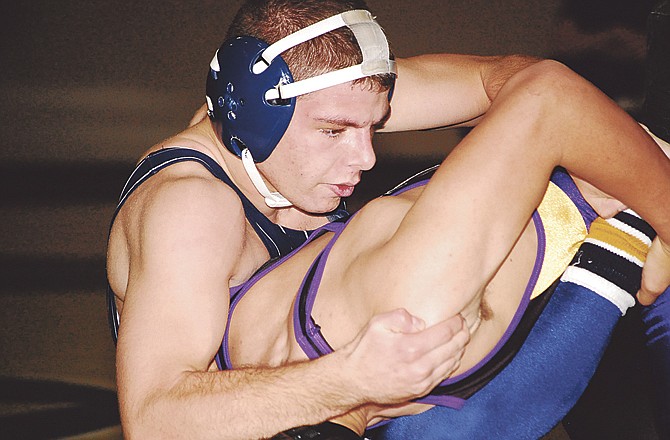 Helias' Matt Anderson works on Hickman's Nate Rojas in their 145-pound match Tuesday at Rackers Fieldhouse. 