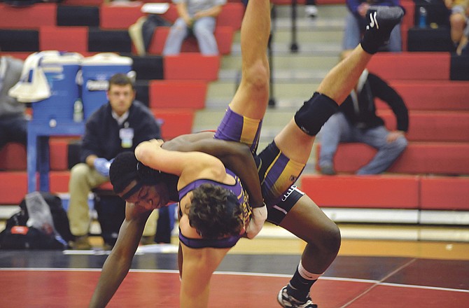 Jefferson City's Isaiah Edoho hurls Camdenton's Will Corliss to the mat during their 189-pound match Tuesday at Fleming Fieldhouse. 