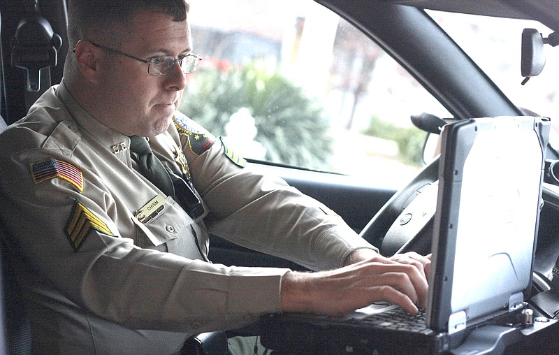 Stephanie Backus/FULTON SUN photo: Sgt. Clay Chism of the Callaway County Sheriff's Department works on his on-board computer during a shift. Chism has been with the department for 10 years.