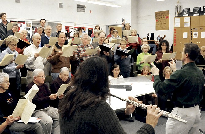 The Jefferson City Cantorum, under the direction of Glen Webb, practice with flutist Janice Hinman for their upcoming concert. The group will perform Christmas songs Saturday at 7 p.m. at the Miller Performing Arts Center. 