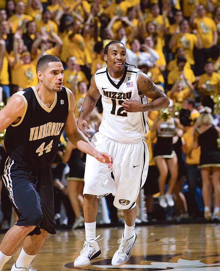 Missouri's Marcus Denmon, right, smiles in front of Vanderbilt's Jeffery Taylor, left, after making a basket late in overtime in an NCAA college basketball game Wednesday, Dec. 8, 2010, in Columbia. Mo. Missouri won 85-82. (AP Photo/L.G. Patterson)