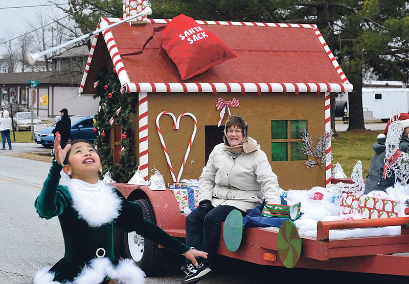 Stephen Brooks photo/FULTON SUN photo: A Baton Twirler walks along with one of the floats in the Holts Summit Christmas Parade Saturday.