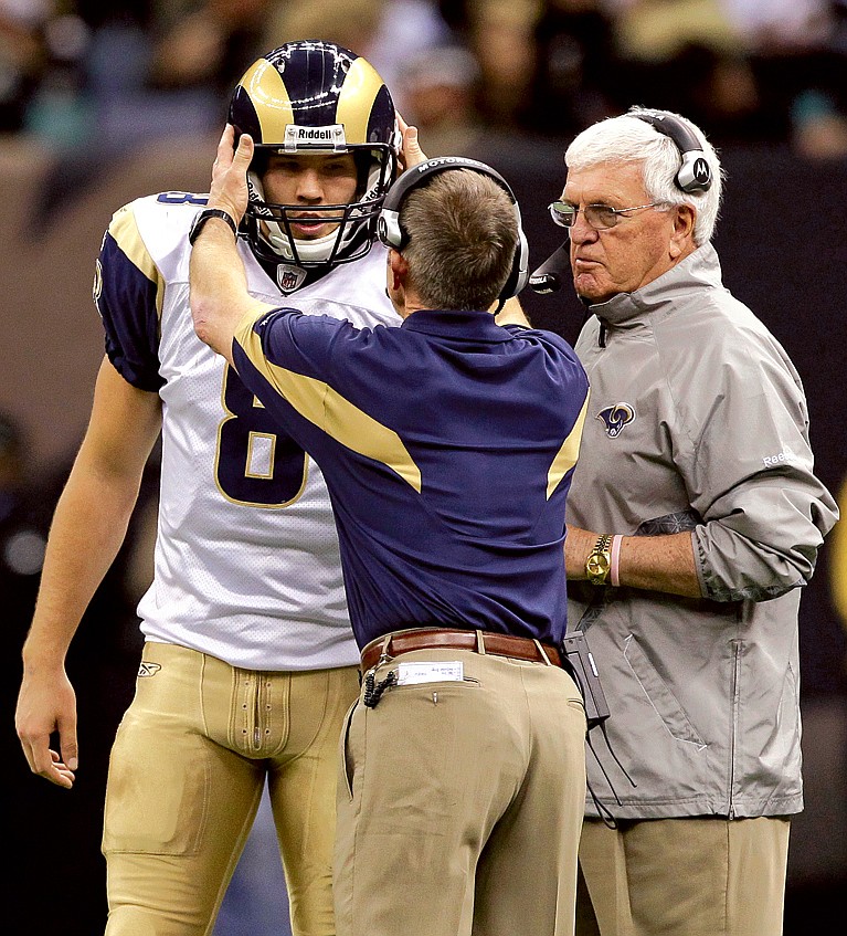 AP
Rams head coach Steve Spagnuolo taps the helmet of quarterback Sam Bradford as they speak with assistant head coach Richard Curl during the second half of Sunday's 31-13 loss to the Saints in New Orleans.